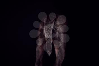 Studio Shot Of Sharpei Puppy Showing Tail Against Black Background