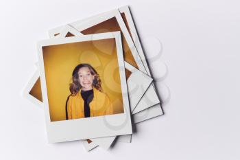 Stack Of Instant Film Photos From Modeling Casting In Studio With Shot Of Young Woman On Top