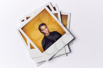 Stack Of Instant Film Photos From Modeling Casting In Studio With Shot Of Young Man On Top