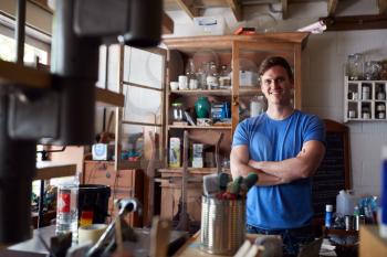 Portrait Of Confident Man Working In Workshop On Upcycling And Craft Projects