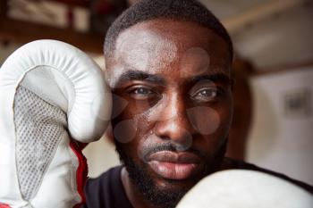 Close Up Portrait Of Male Boxer In Gym Wearing Boxing Gloves