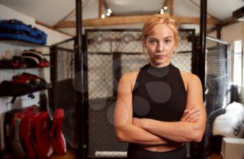 Portrait Of Female Mixed Martial Arts Fighter Training In Gym