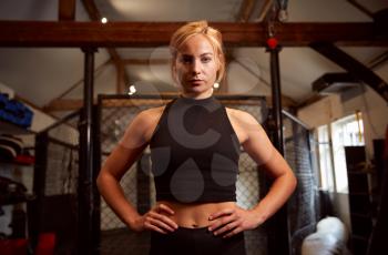 Portrait Of Female Mixed Martial Arts Fighter Training In Gym