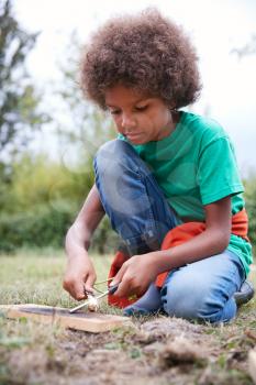 Boy On Outdoor Camping Trip Learning How To Make Fire