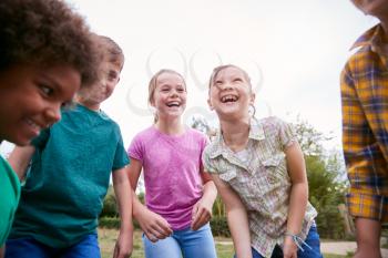 Group Of Children On Outdoor Activity Camping Trip Having Fun Playing Game Together