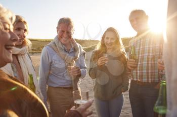 Multi-Generation Adult Family Celebrating With Wine On Winter Beach Vacation