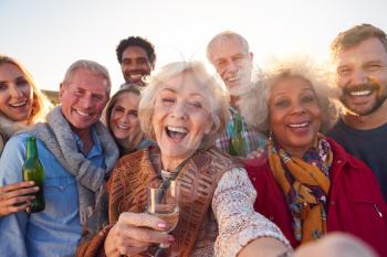 Multi-Generation Adult Family Taking Selfie At Outdoor Party Celebration