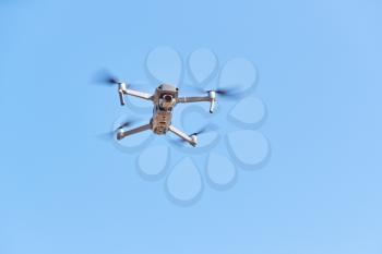 Drone With Camera Flying Against Clear Blue Sky