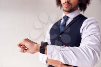 Close Up Of Businessman Wearing Suit Looking At Smart Watch