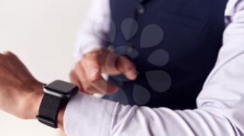 Close Up Of Businessman Wearing Suit Looking At Smart Watch
