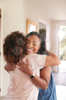 Loving Senior Mother Hugging Adult Daughter Indoors At Home