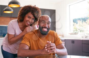Portrait Of Smiling African American Adult Son With Mother In Kitchen At Home