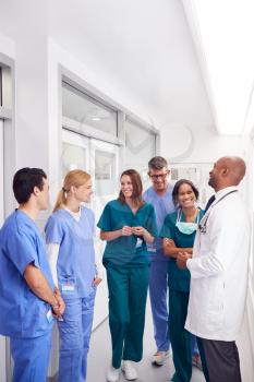 Multi-Cultural Medical Team Having Meeting In Hospital Corridor