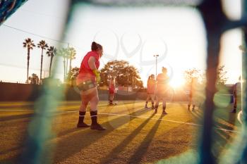 View Through Goal Net Of Womens Football Team Playing Soccer Match