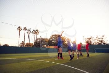 Womens Football Team Celebrating Scoring Goal In Soccer Match On Outdoor Astro Turf Pitch