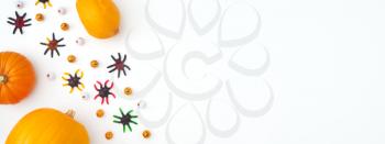 Overhead Halloween Banner Composed Of Pumpkins With Candy Spiders And Eyeballs On White Background