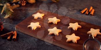 Freshly Baked Star Shaped Christmas Cookies On Board Ready For Decoration