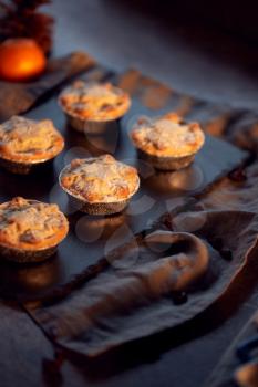 Freshly Baked Mince Pies On Table Set For Christmas With Cinnamon Sticks And Orange