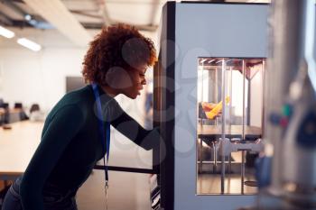 Female College Student Studying Engineering Using 3D Printing Machine