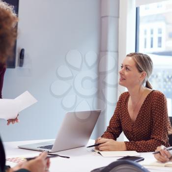 Mature Businesswoman Sitting At Table In Office  Meeting Room