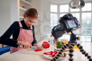 Young Girl Vlogger Making Social Media Video About Cooking For The Internet At Home