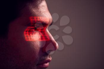 Facial Recognition Technology Concept As Man Has Red Grid Projected Onto Eye In Studio