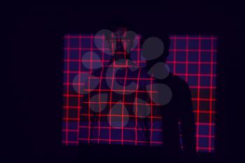 Facial Recognition Technology Concept As Man Has Red Grid Projected Onto Body In Studio