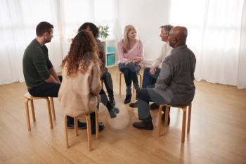 People Attending Support Group Meeting For Mental Health Or Dependency Issues In Community Space