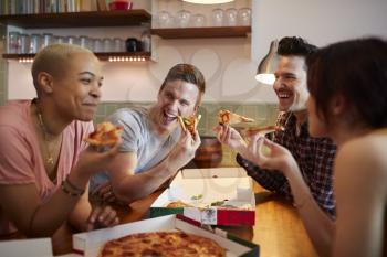 Group Of Gay Friends Meeting At Home And Eating Takeaway Pizza
