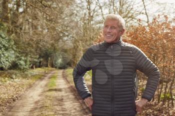Smiling Senior Man On Walk In Autumn Countryside Exercising During Covid 19 Lockdown