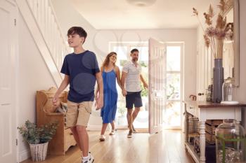Parents With Son Looking Around New Home Before They Move In