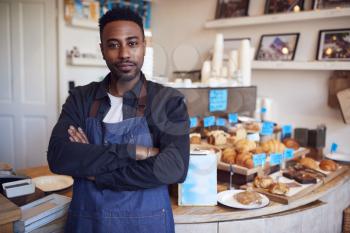 Portrait Of Male Owner Of Coffee Shop Standing By Counter