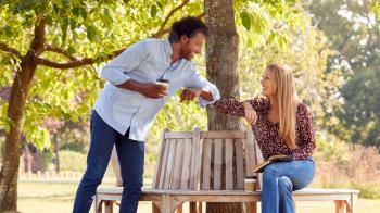 Couple Greeting By Touching Elbows On Socially Distanced Meeting In Outdoors During Health Pandemic