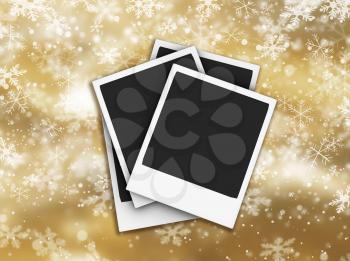 Polaroids on dolden background of falling snowflakes