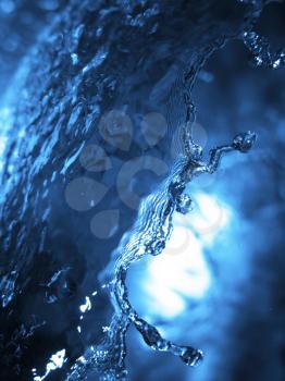 Splashing water with bright blue light reflecting