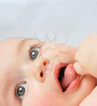 Close up shot of a baby boy sucking his hand