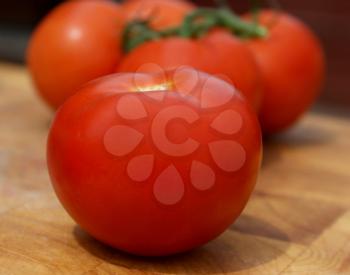 Close up shot of tomatoes on old wooden chopping board