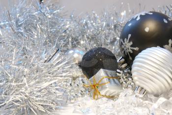 Christmas background with baubles, gift and silver tinsel