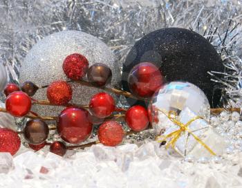 Christmas background with decorations nestled in ice and tinsel