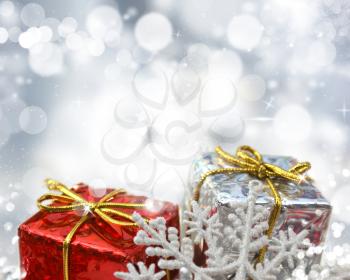 Christmas gifts on a silver bokeh lights background