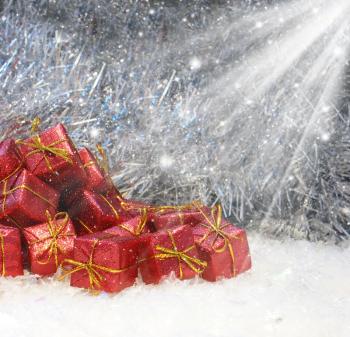 Red and gold Christmas gifts in snow
