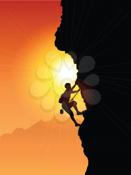 Silhouette of a rock climber against a sunset sky