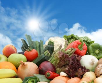 Royalty Free Photo of Assorted Fruits and Vegetables Against a Blue Sky
