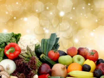 Royalty Free Photo of Assorted Fruits and Vegetables Against a Gold Background