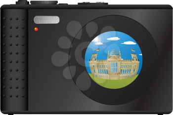 Compact digital camera with snapshot of Berlin's Parlament building on the lens.