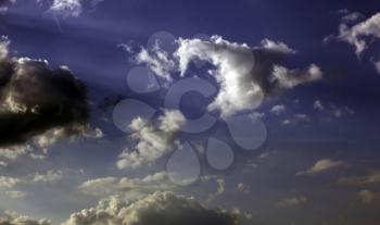 Dramatic background scene with clouds over a blue sky