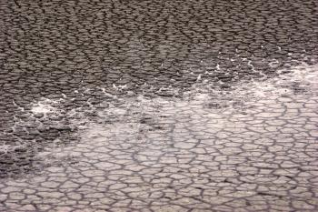 Royalty Free Photo of Water on Cracked Ground