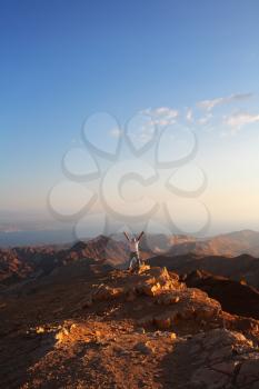 Classical bible landscape - desert Sinai in a morning fog, Red sea and the lonely tourist