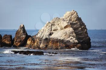 Picturesque rock, out of the water, near the Pacific coast USA