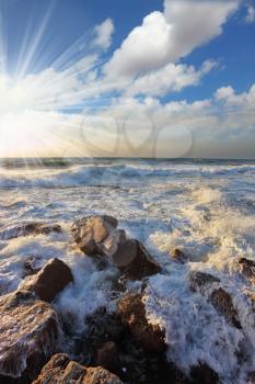 Gorgeous sunset on the Mediterranean. Storm waves crash on the breakwater at the quay. Tel Aviv, the spring
